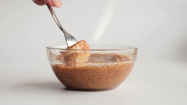 A video of "nasi impit" or pressed rice dip into chicken "kuah kacang"or peanut sauce. Popular serve during Eid or snack time.