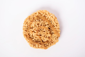 Sweet crispy rice with cane sugar drizzle isolated on white background, Local Thai snack (Khao Tan)