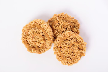 Sweet crispy rice with cane sugar drizzle isolated on white background, Local Thai snack (Khao Tan)