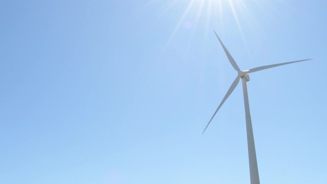 Wind turbine energy moving blades a sunny day - Loop