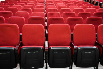 Fototapeta premium red velor chairs in the auditorium, without people 