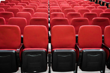 red velor chairs in the auditorium, without people
