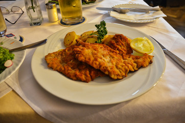 Two Schnitzel with Potatoes and Lemon and Beer