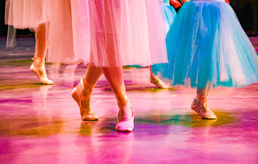 ballerina steps in Czech pointes on stage, colorful ballet, pink and blue ballet tutus, dance class
