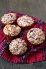Fresh and warm homemade muffins on  red tableclothe