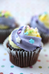 Yellow and purple easter cupcake colorful background