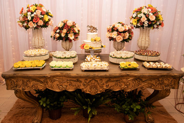 Wedding Setup. Cake table with sweet, decoration and flowers