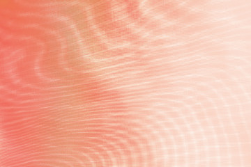 abstract background: unique wavy pattern of overlaying two grids, blurred and tinted to the color of the living coral
