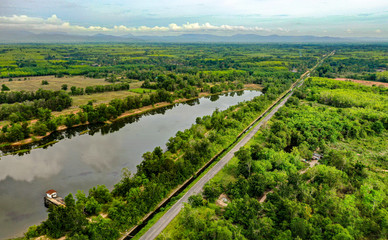 Aerial top view of road in green trees in forest background,Thailand