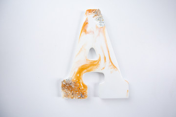 gold and white letter A