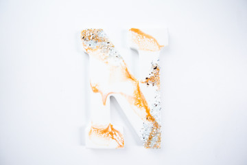 gold and white letter N