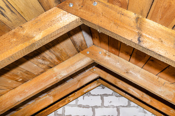 Roof made of rafter-type roof truss, close-up view from the inside, wooden roof.