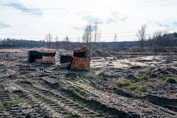 Reinforcing rods protruding from the ground in a place where there will be concrete poles, the...