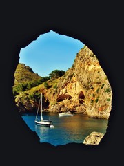 Window in rock featuring view at famous beach Sa Calobra in Spain, Mallorca island