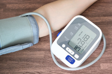 Man check blood pressure monitor and heart rate monitor with digital pressure gauge. Health care...