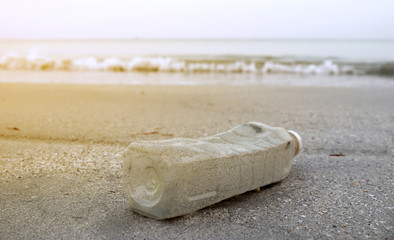 Bottle plastic on the beach ground show long life garbage concept