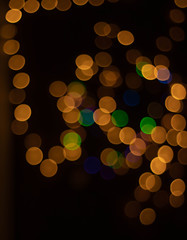 Golden christmas background with bokeh lights.