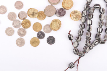 Rosary, banknotes and coins, islamic banking/finance concept.