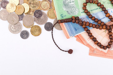 Rosary, banknotes and coins, islamic banking/finance concept.