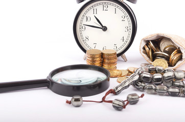 Rosary, coins in a gunny sack and alarm clock. Islamic banking/finance concept on over white background.