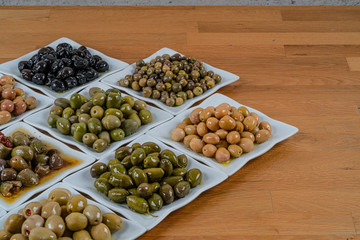 Olives assortment in bowl with oil. 