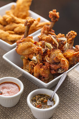 fried chicken drumsticks and breaded chicken breast strips with dressings