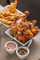 fried chicken drumsticks and breaded chicken breast strips with dressings