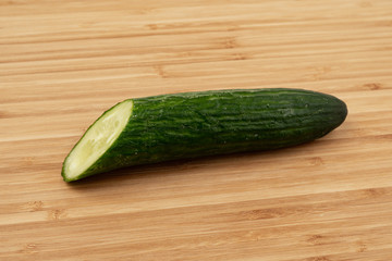 Green cucumber on a wooden background
