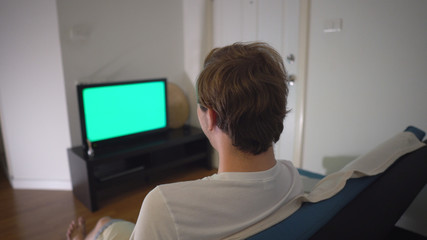 Over Shoulder Man Watching Green Screen TV