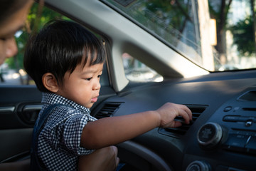 Little boy playing radio control inside car