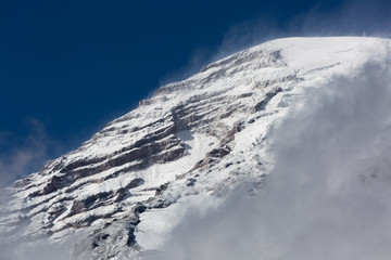 Fototapeta na wymiar Snowy Mt. Rainier over low clouds, blue sky