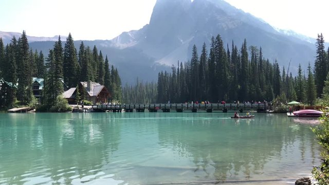 Emerald Lake,  British Columbia/ Canada - July 20, 2019: Green Alpine Glacier Lake in Canadian Rocky Mountains. People Kayaking in the summer. Yoho National Park in Canada