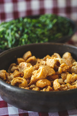 Brazilian pork scratching ( torresmo ) and cabbage ( couve )