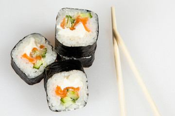 Set of eel sushi rolls with chopsticks.