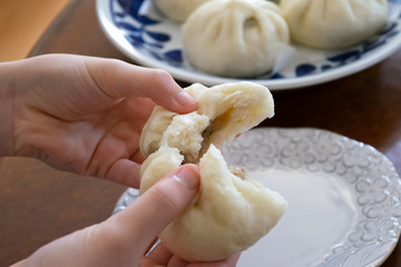 自宅で手作りした肉まん　蒸したての肉まんを半分に割る様子