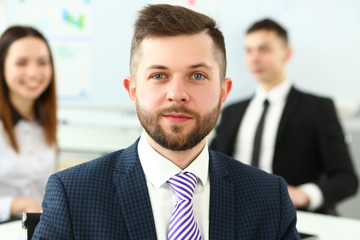 Cheerful clerk worker wearing suit and tie looking in camera in office headshot