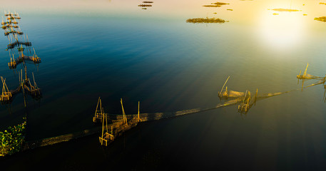 Naklejka premium High angle view of fish farming on a calm river in Myanmar 