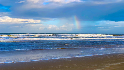 beach in the morning with rainbow
