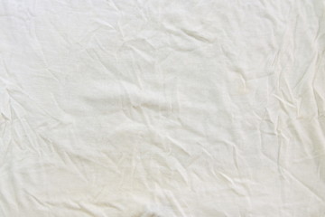 Fototapeta na wymiar Crumpled white linen fabric cotton for wallpaper design. Brown weave cotton background texture.