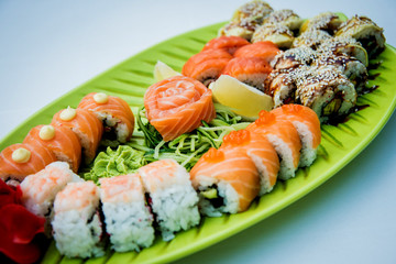 Large sushi set on the green plate.