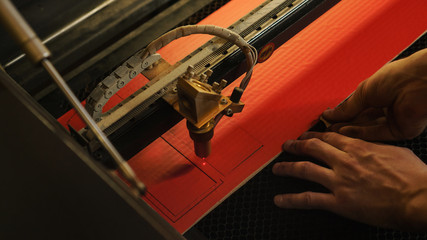 Laser cutting beam high precision on a paperboard. Modern machine industrial technology of...