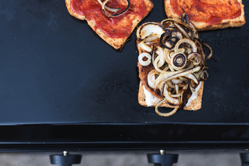 plant-based barbecue, vegan patties on bread with onion and hot sauce on bbq