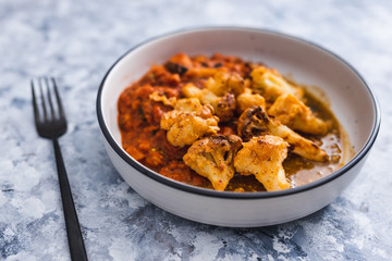 plant-based food, aubergine and tomato bake with air fried vegan buffalo cauliflower