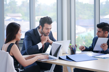 Business people meeting in a room and they brainstorming and talking and discussing about report