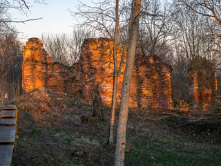 Ruined brick wall of a medieval castle, beautiful sunset colors in spring