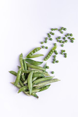 Healthy fresh green peas top view flat lay with white background. 