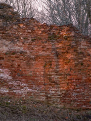 Ruined brick wall of a medieval castle, beautiful sunset colors in spring