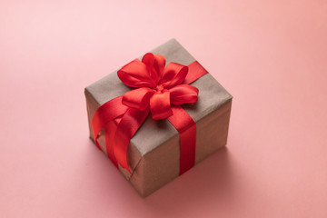White gift box with red ribbon, black background flat lay for stock image