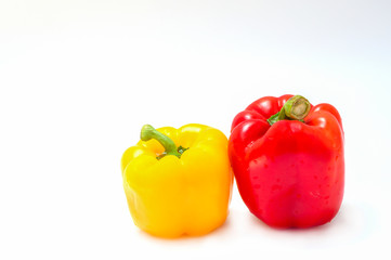 Two yellow and red bell peppers