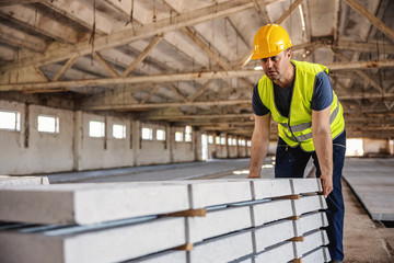 Blue collar worker doing his job at construction site.
